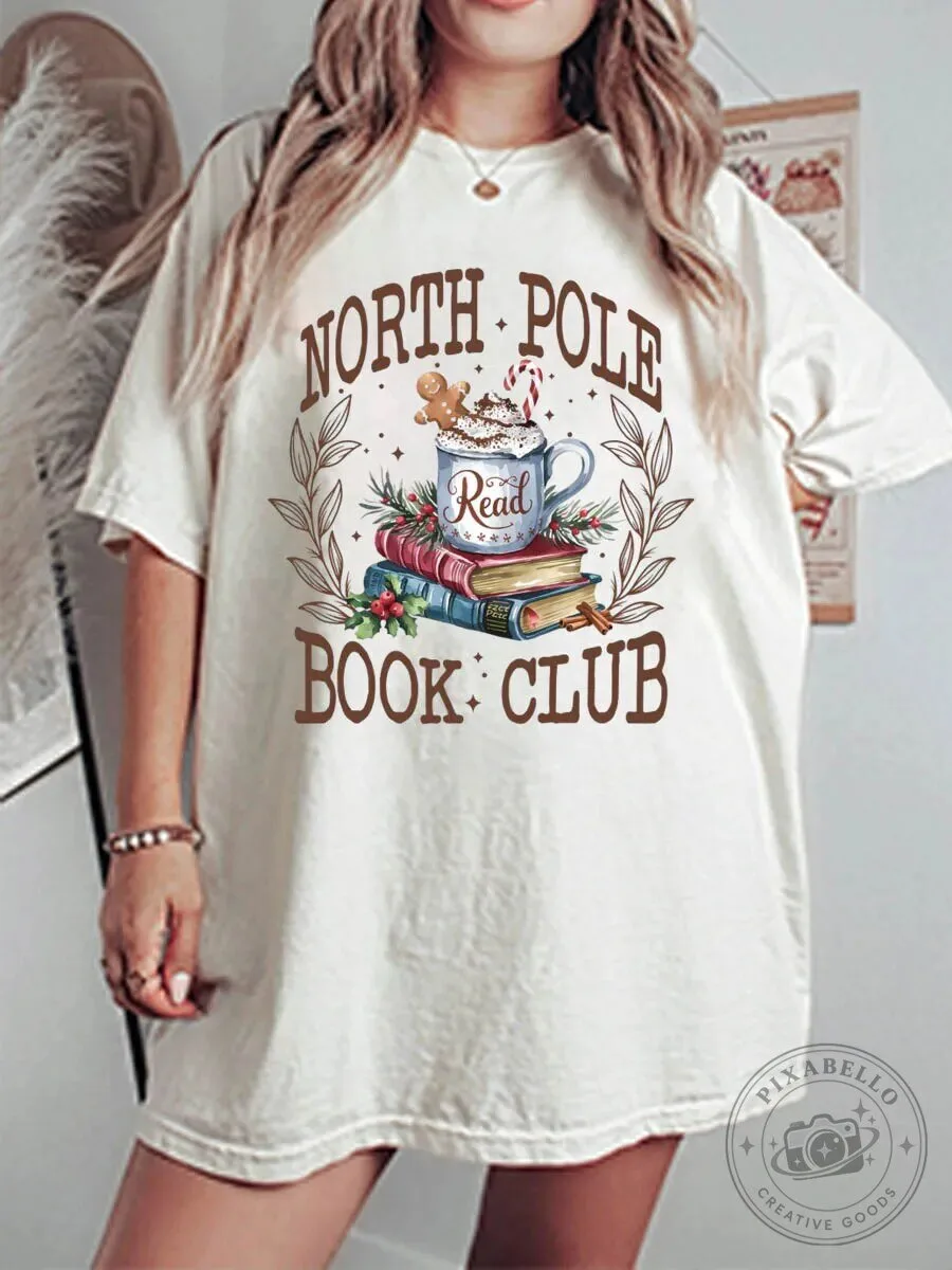North Pole Book Club Christmas Hot Cocoa and Books Graphic T-Shirt 1 North Pole Book Club Christmas Hot Cocoa and Books Graphic T-Shirt